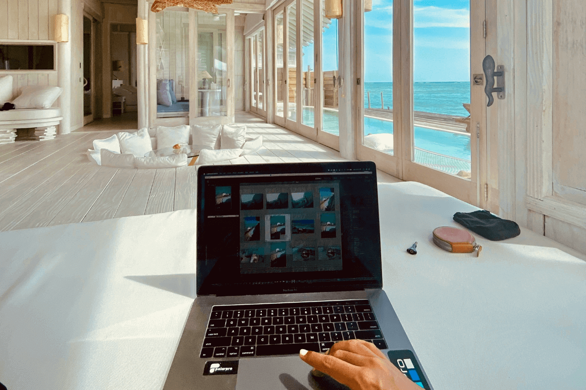 Laptop on desk inside a luxury beach villa with ocean views